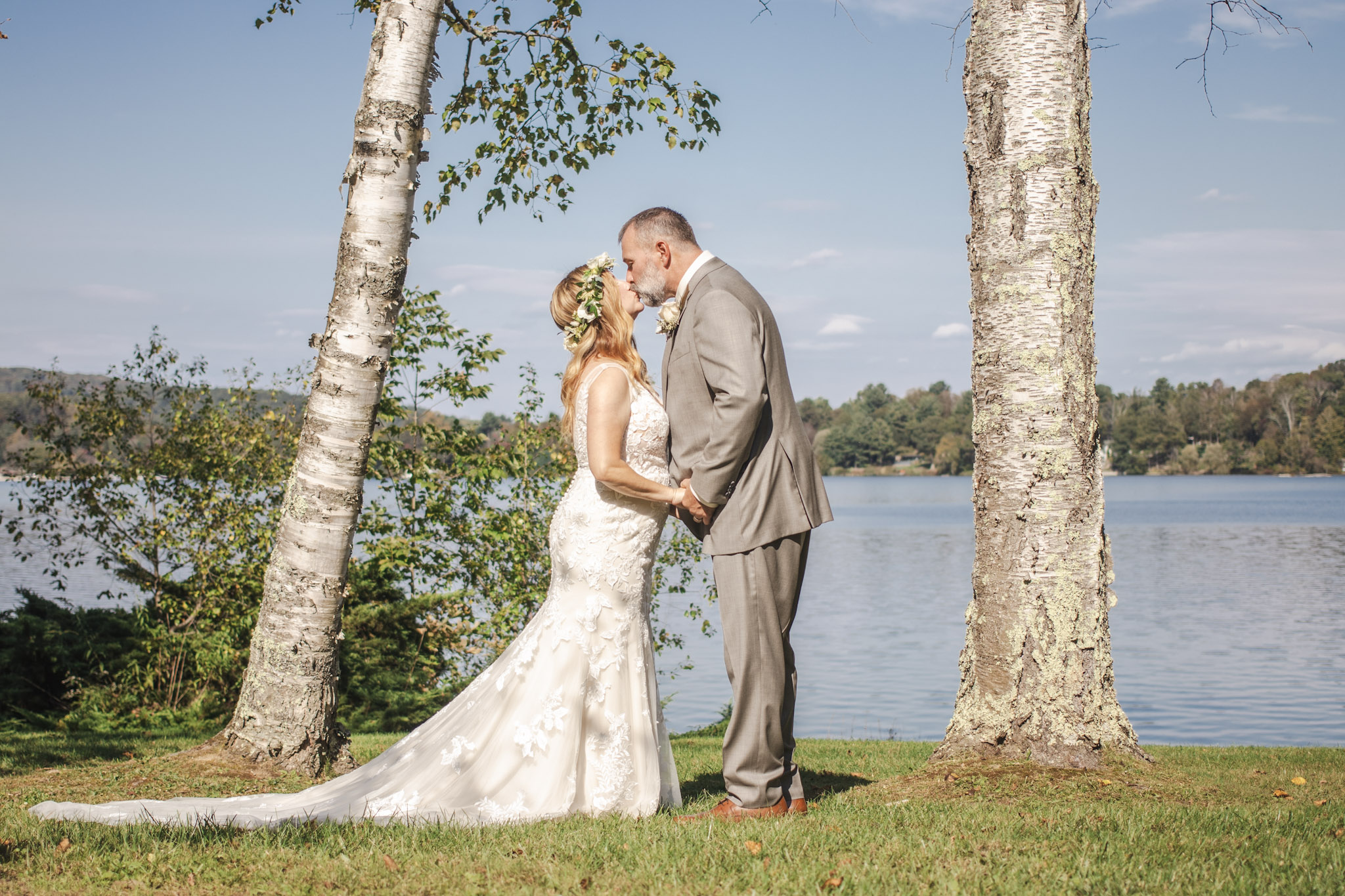 Bride and groom portrait by the water