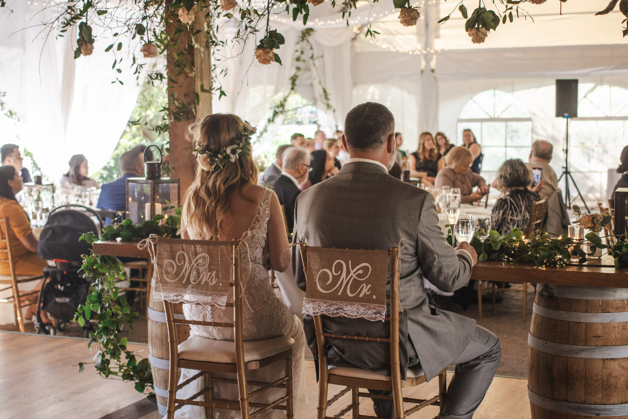 Wedding reception photographed behind the couple
